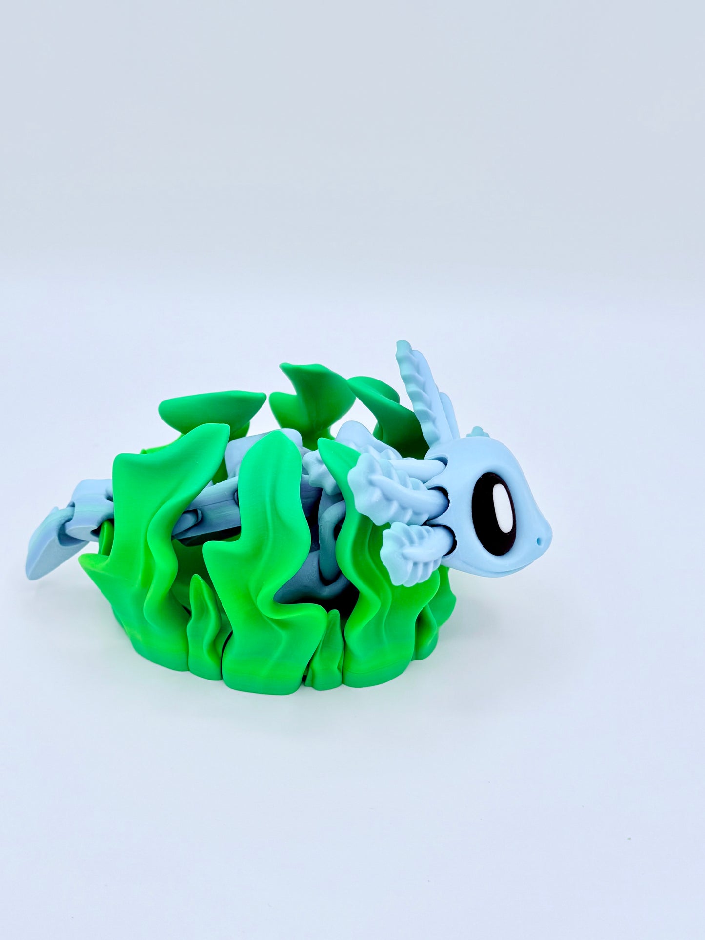 Axolotl with seaweed bed.